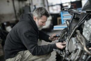 mechanic fixing a motor bike